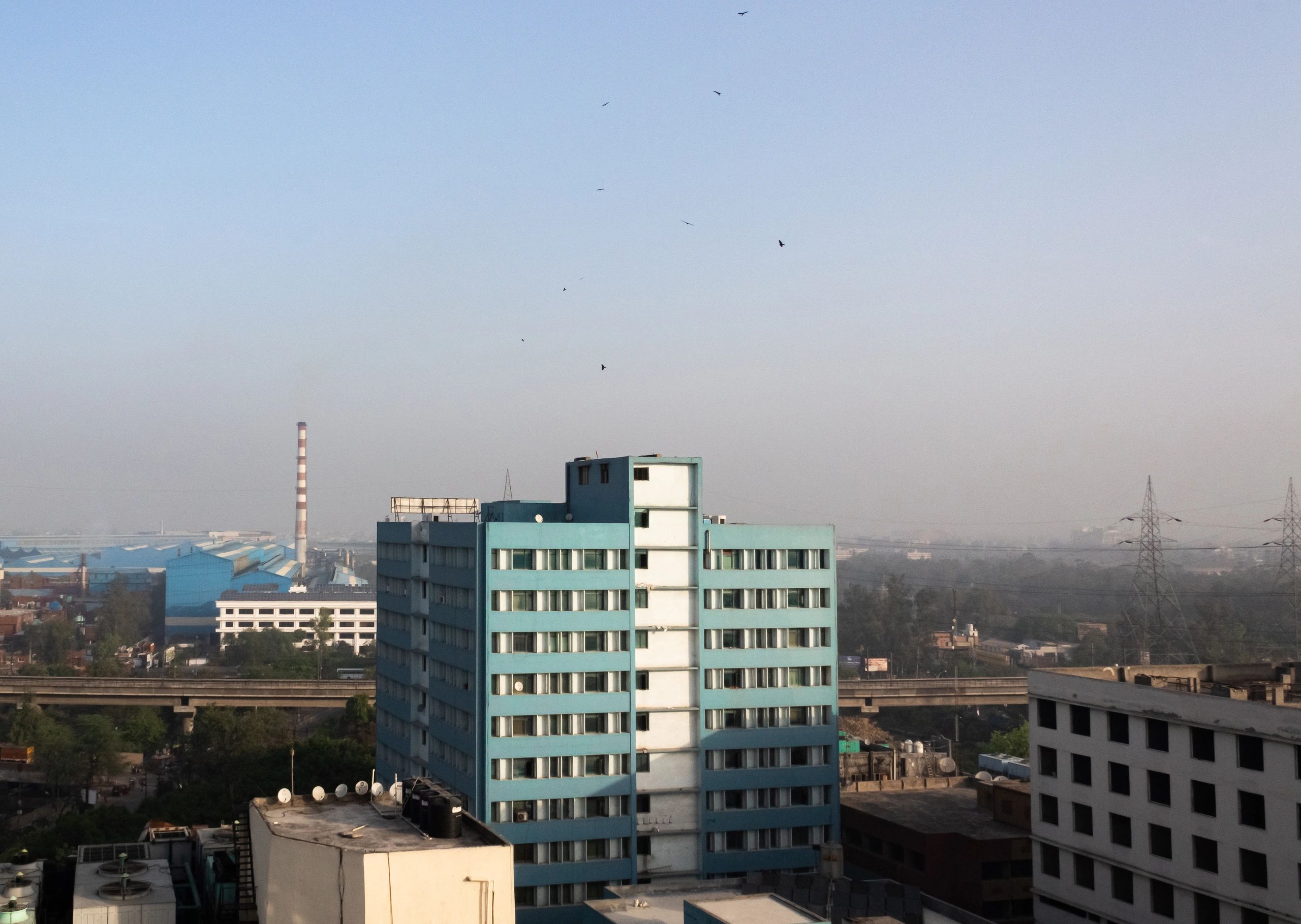 Factory building with chimney and highway nearby